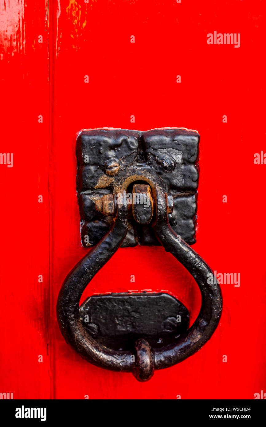 Close up of a door knocker or handle on red door Stock Photo