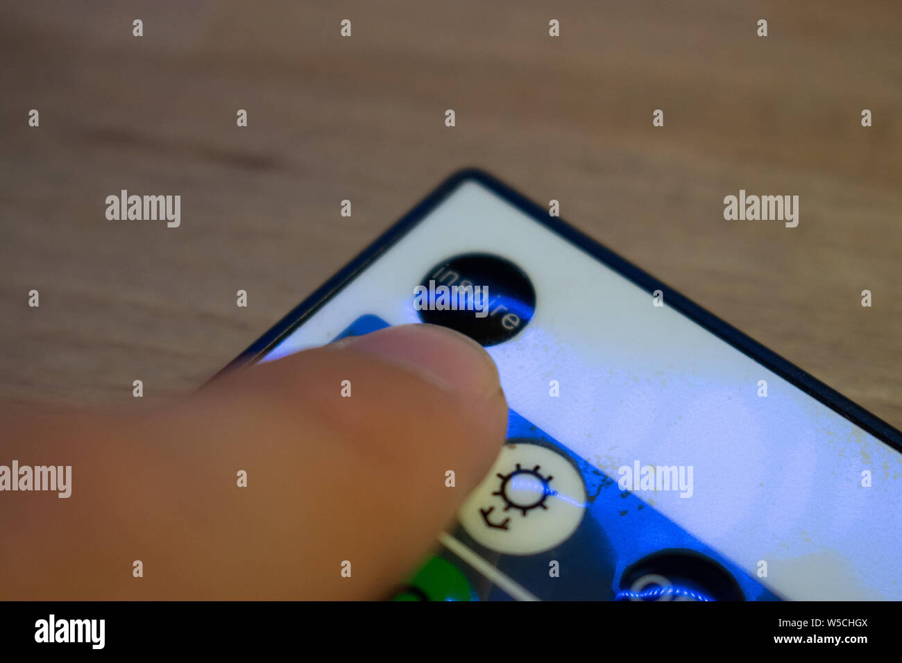 Macro photo of a person pressing an 'Inspire' button, Inspirational concept, Motivational cocept (Focus on the button or on the finger) Stock Photo