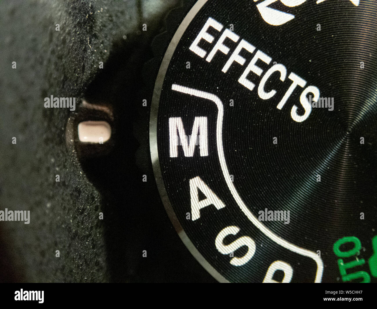 Macro of a Nikon DSLR camera mode dial turned on manual mode Stock