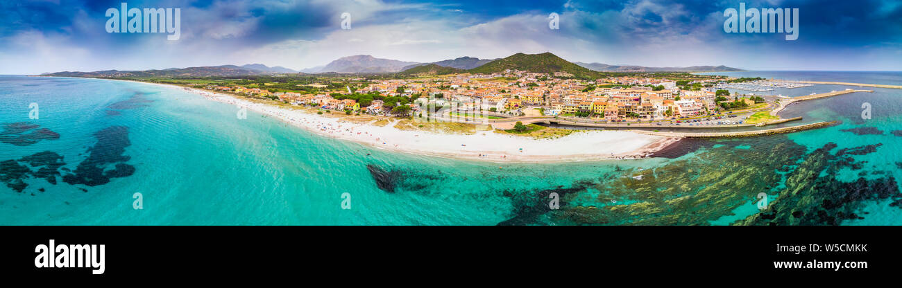 Graniro beach with azure clear water and La Caletta town, Sardinia, Italy, Europe. Stock Photo