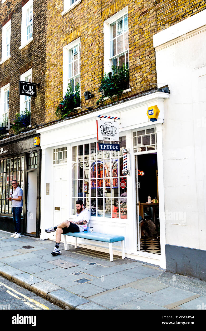 Johnny's Chop Shop barbers and tattoo parlour in Carnaby, Soho, London, UK Stock Photo