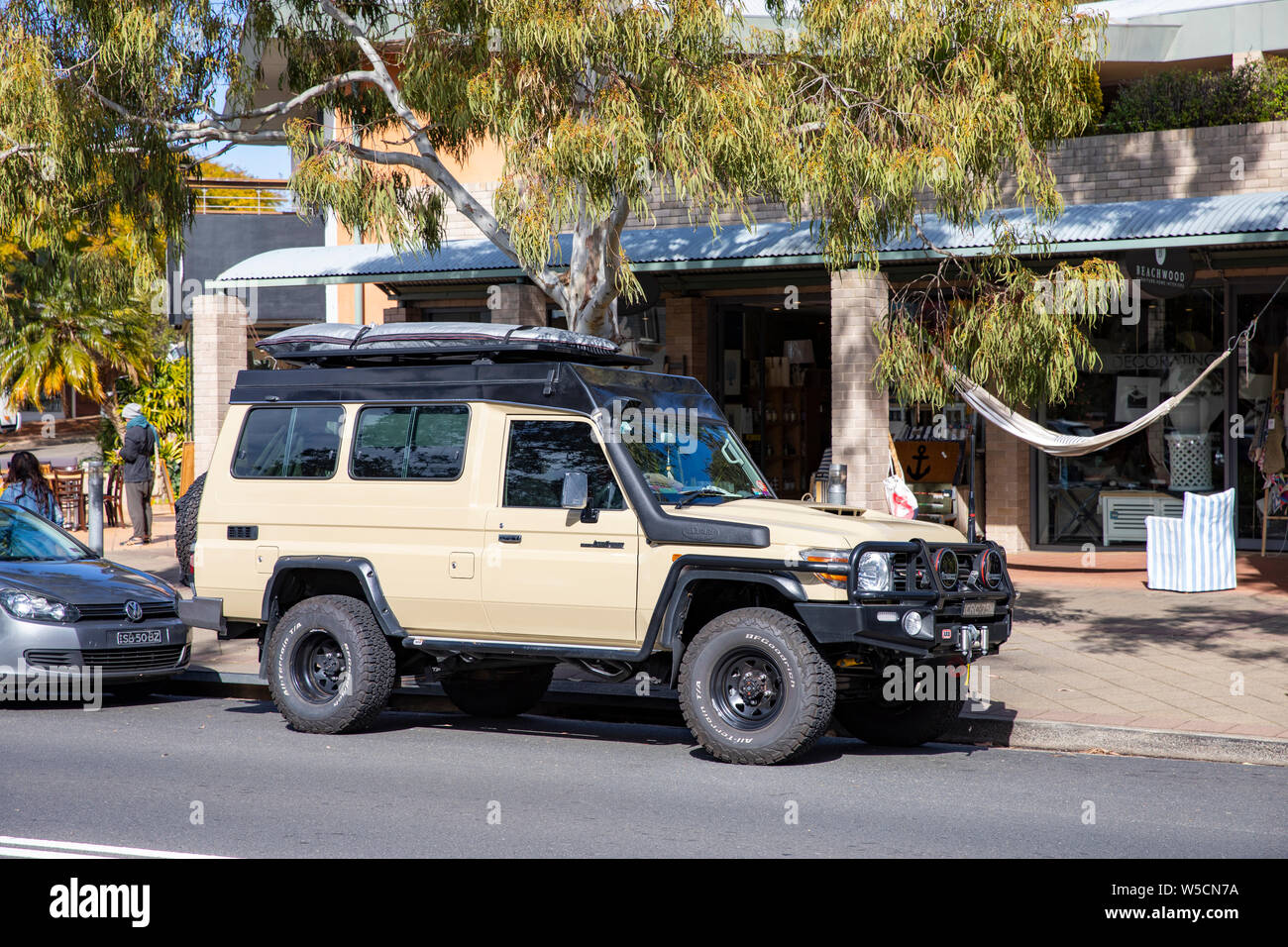 Toytoa landcruiser troopcarrier troopy 78 model in beige parked in a Sydney street but equipped for off road overlanding travel,Australia Stock Photo