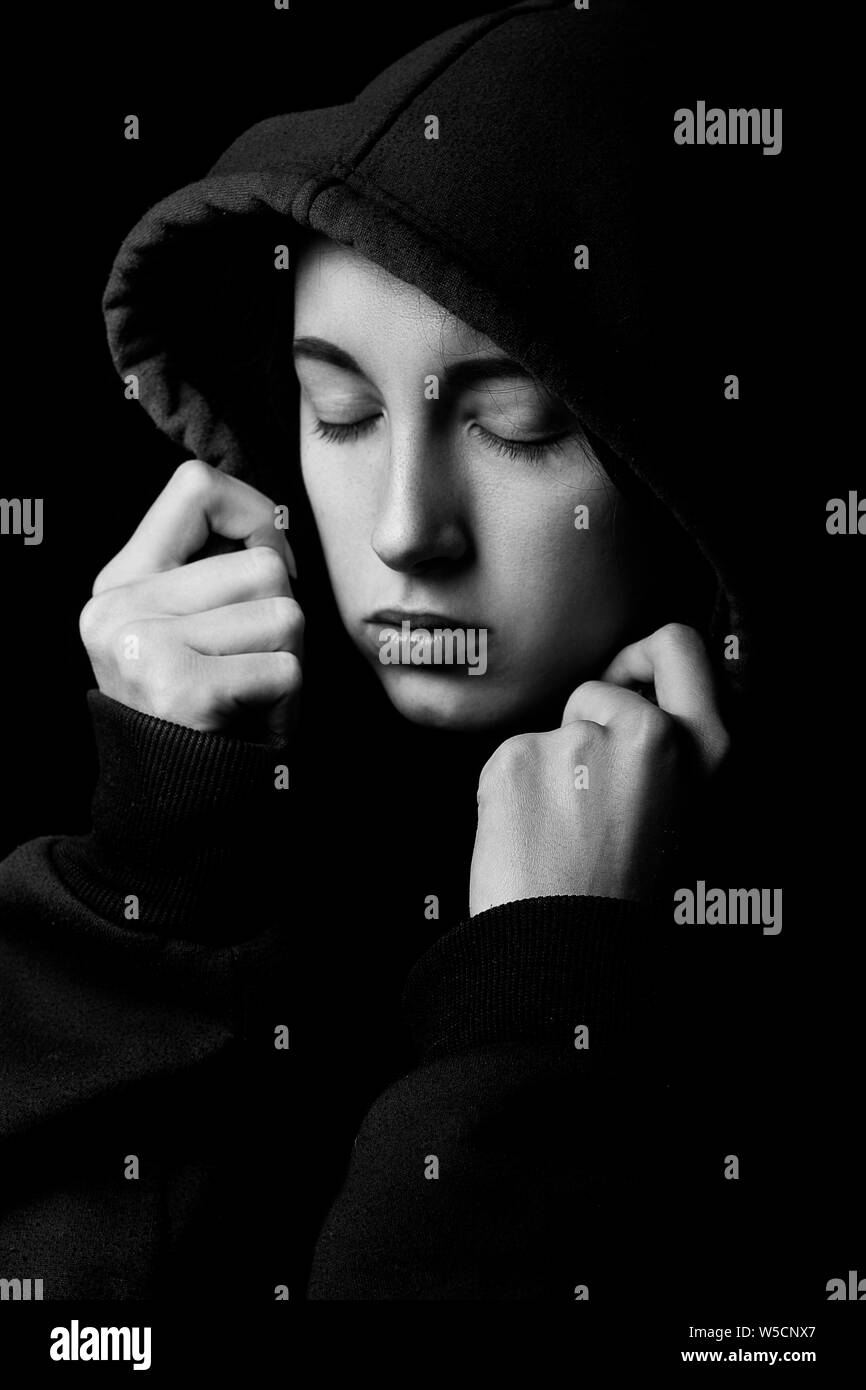 Sad Girl In Hood Closed Eyes On Black Background Monochrome Stock Photo Alamy