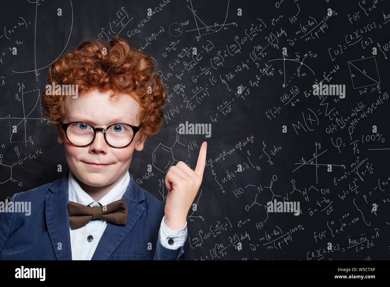 Happy kid student pointing up on science background Stock Photo