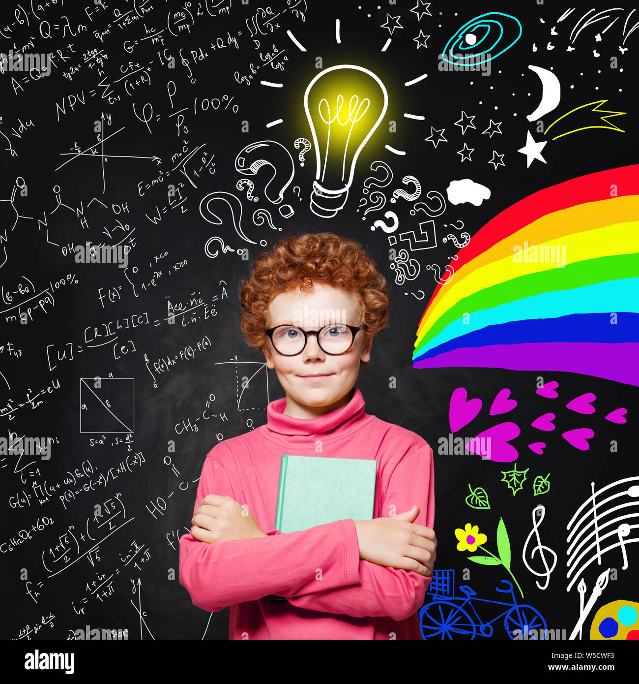Portrait of cute redhead kid with light bulb. Curious child with colorful science and arts scetch. Kids education concept Stock Photo