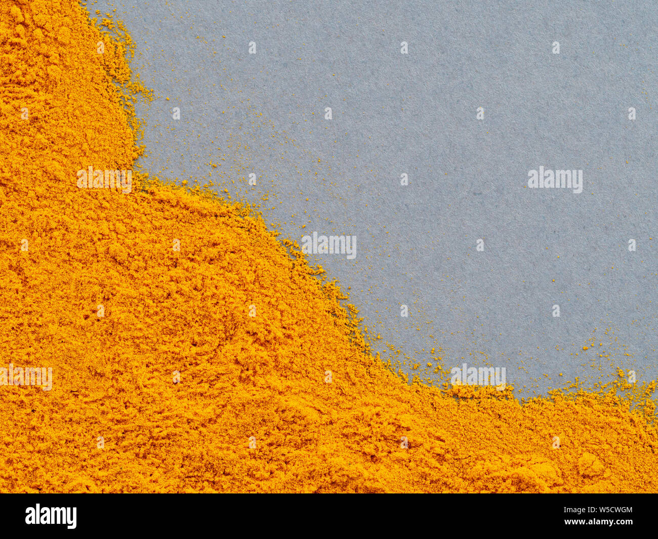 Turmac Gray Color Turmeric Powder or Curcuma longa on gray background. Top view. Copy ...