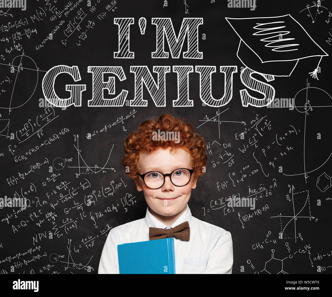 Curious smart kid little school boy genius on blackboard background Stock Photo