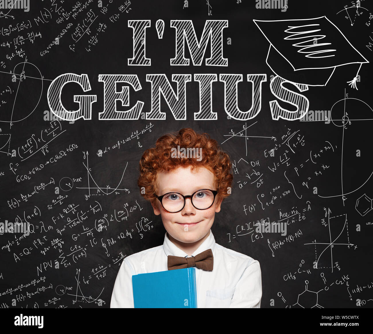 Curious smart kid little school boy genius on blackboard background