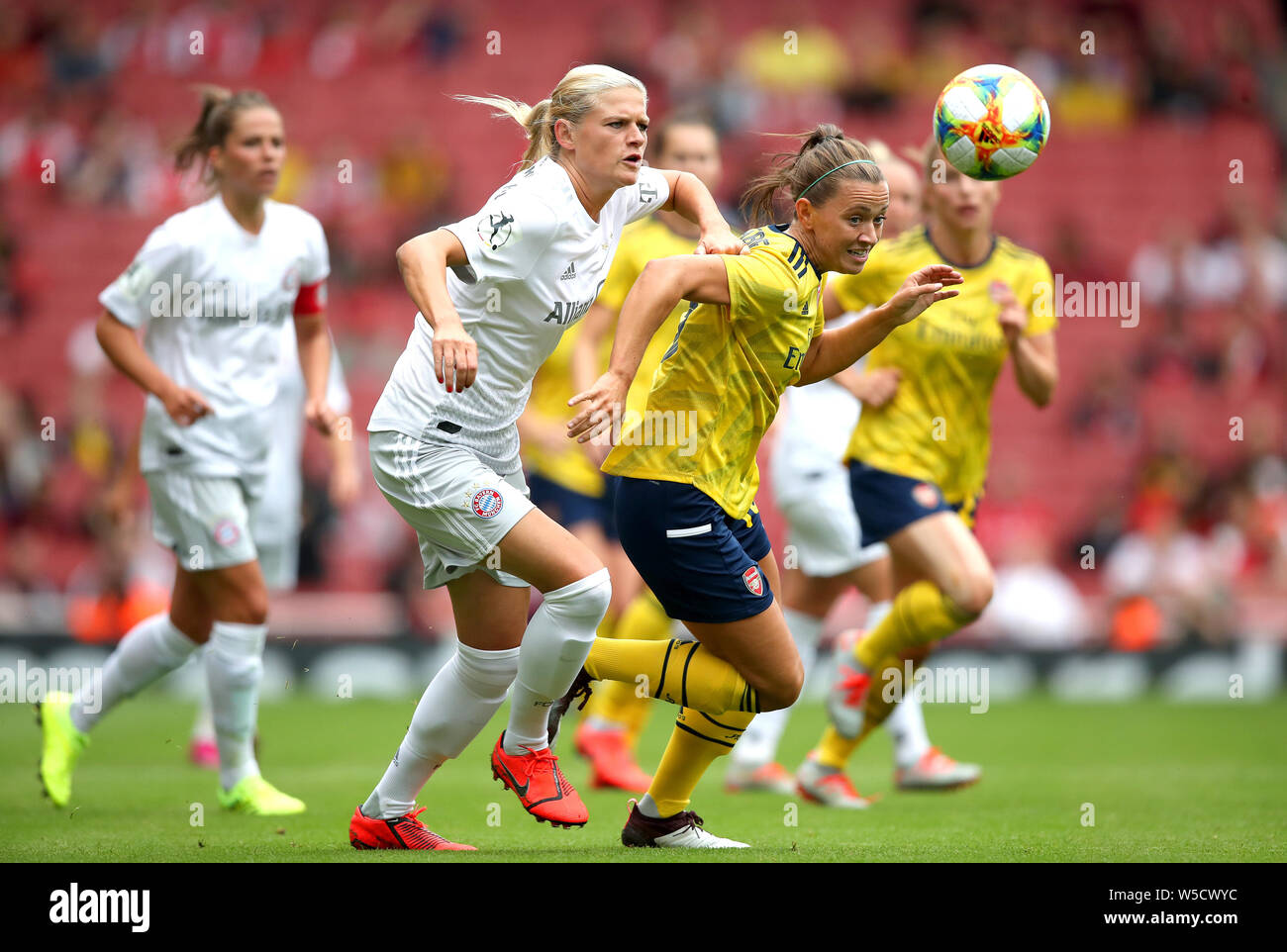 Arsenal's Katie McCabe (right) and Bayern Munich's Carina Wenninger battle for the ball during the Emirates Cup match at the Emirates Stadium, London. Stock Photo