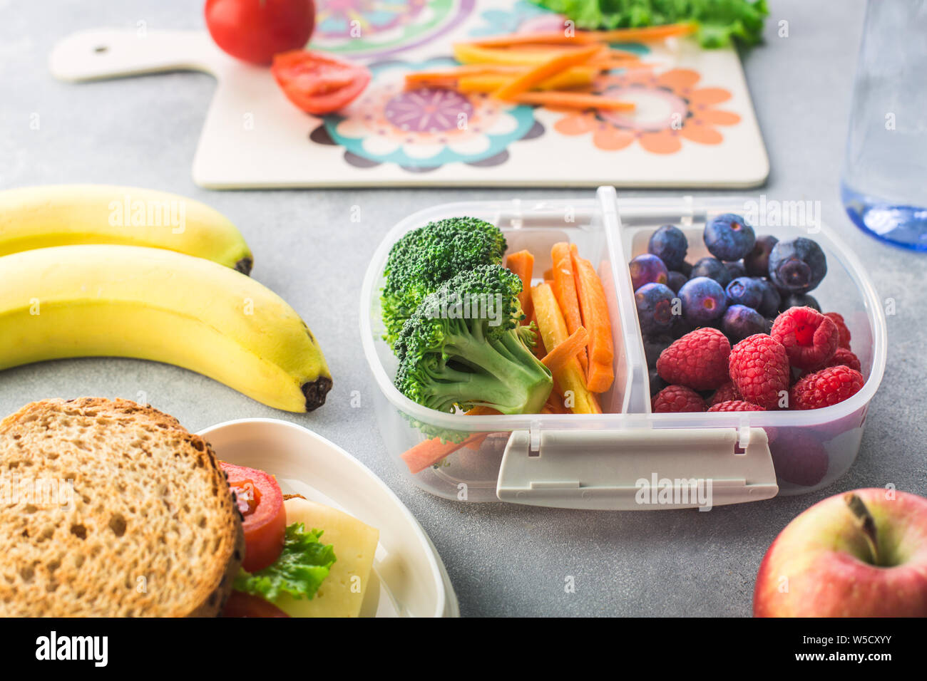 Mother giving healthy lunch for school in the morning Stock Photo