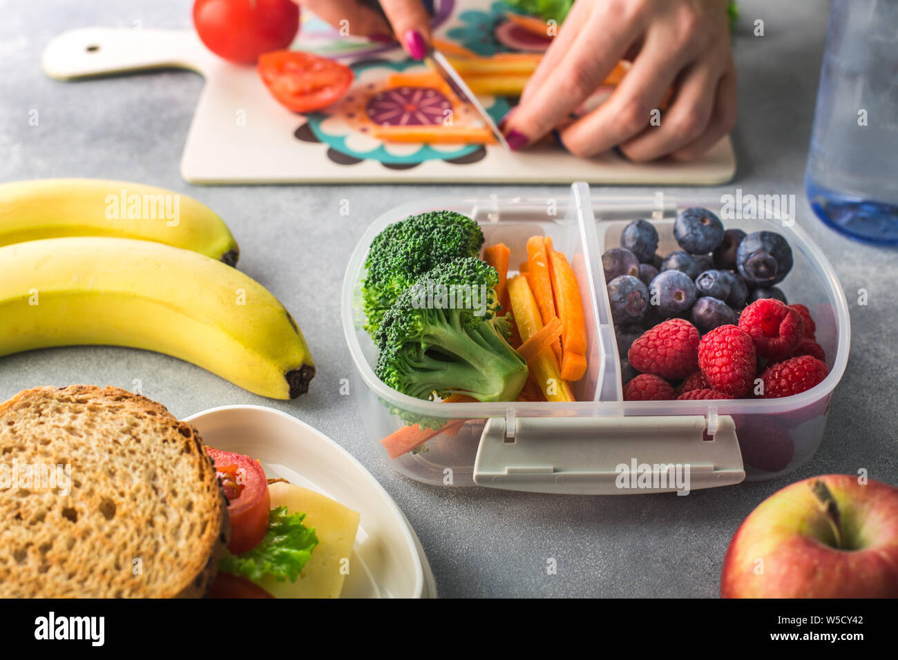 Mother giving healthy lunch for school in the morning Stock Photo