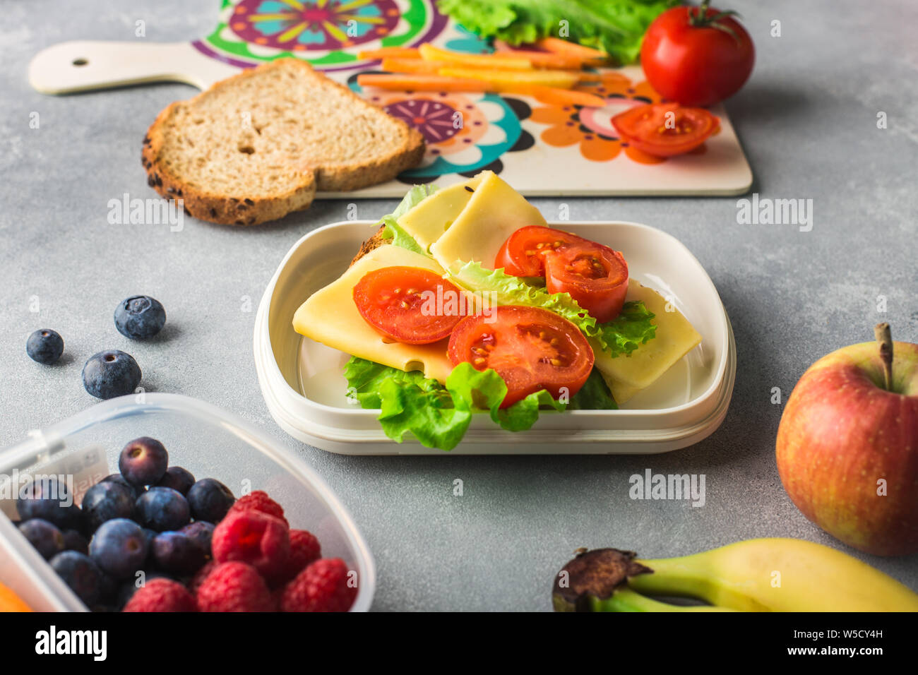 Mother giving healthy lunch for school in the morning Stock Photo