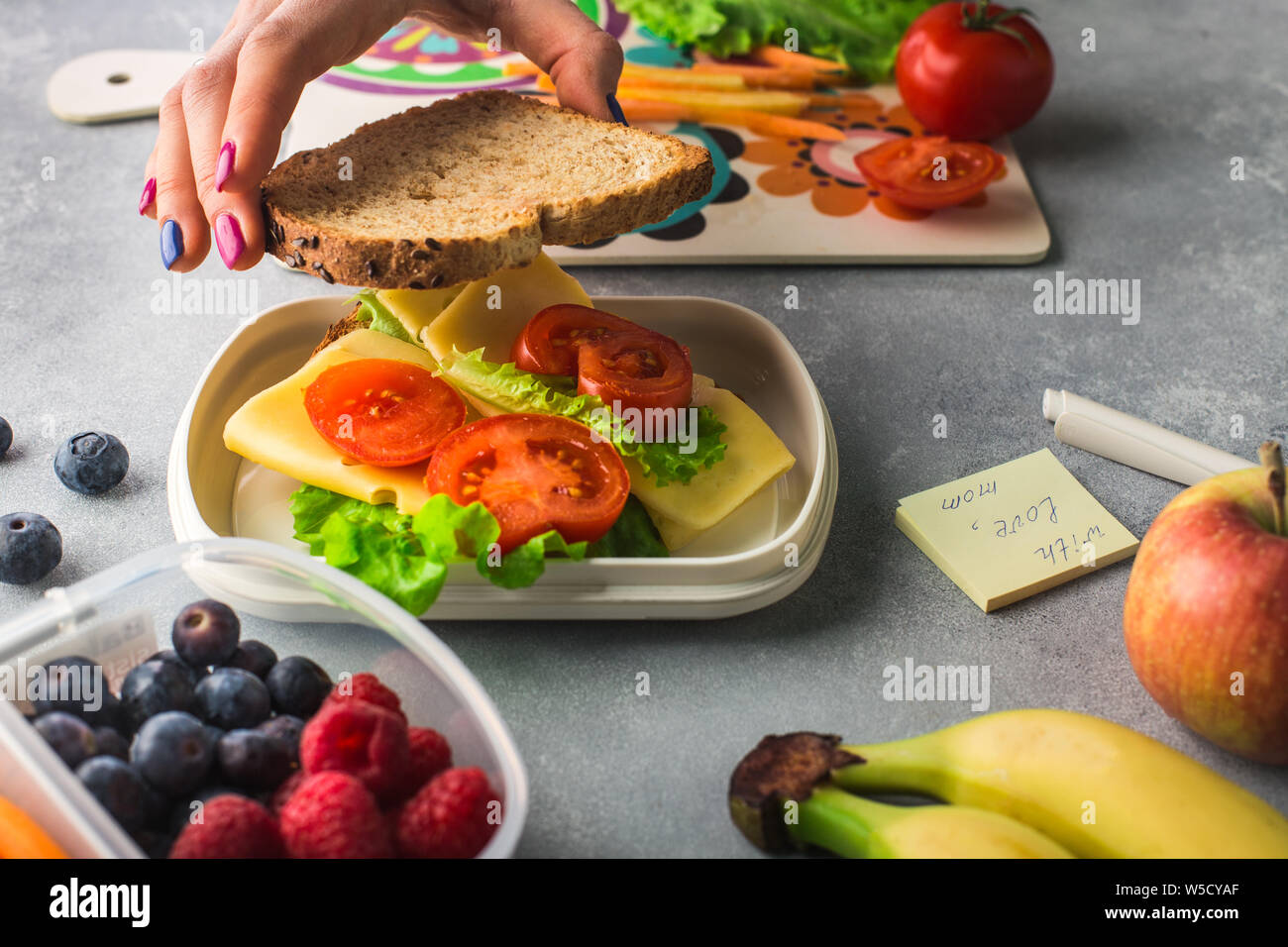 Mother giving healthy lunch for school in the morning Stock Photo