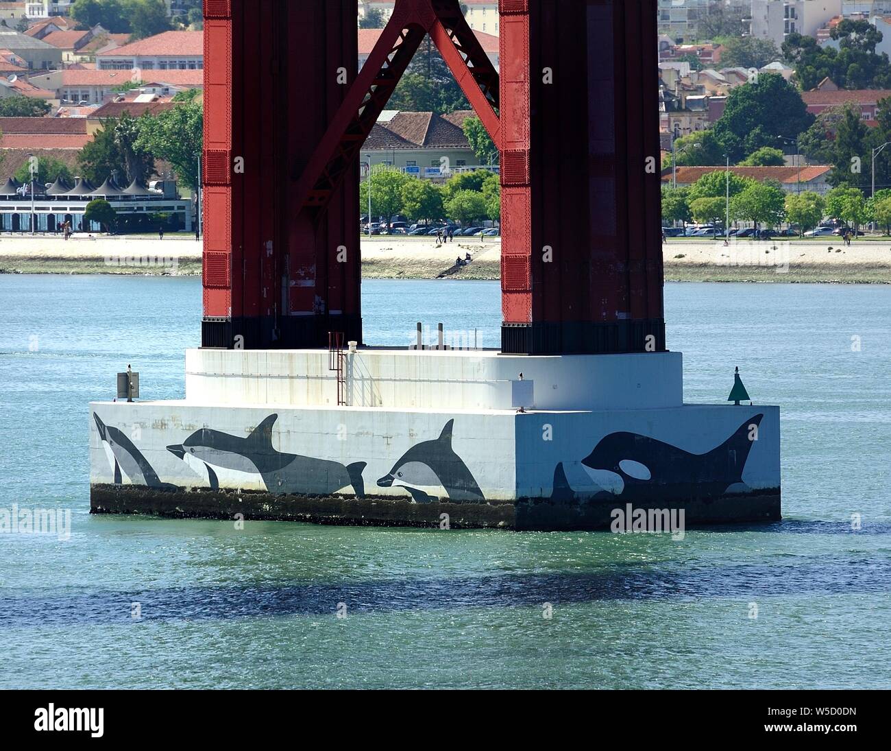 Dolphin painting on the Sturctual base of the 25th April Bridge Stock