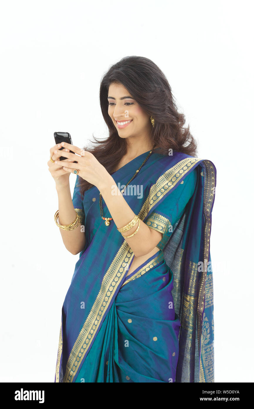 Indian woman text messaging and smiling Stock Photo - Alamy