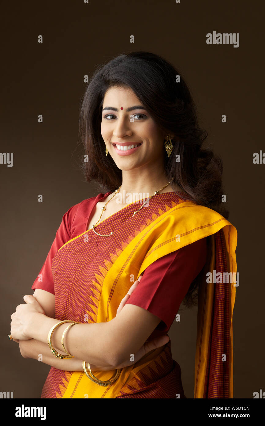 Woman smiling with her arms crossed Stock Photo - Alamy