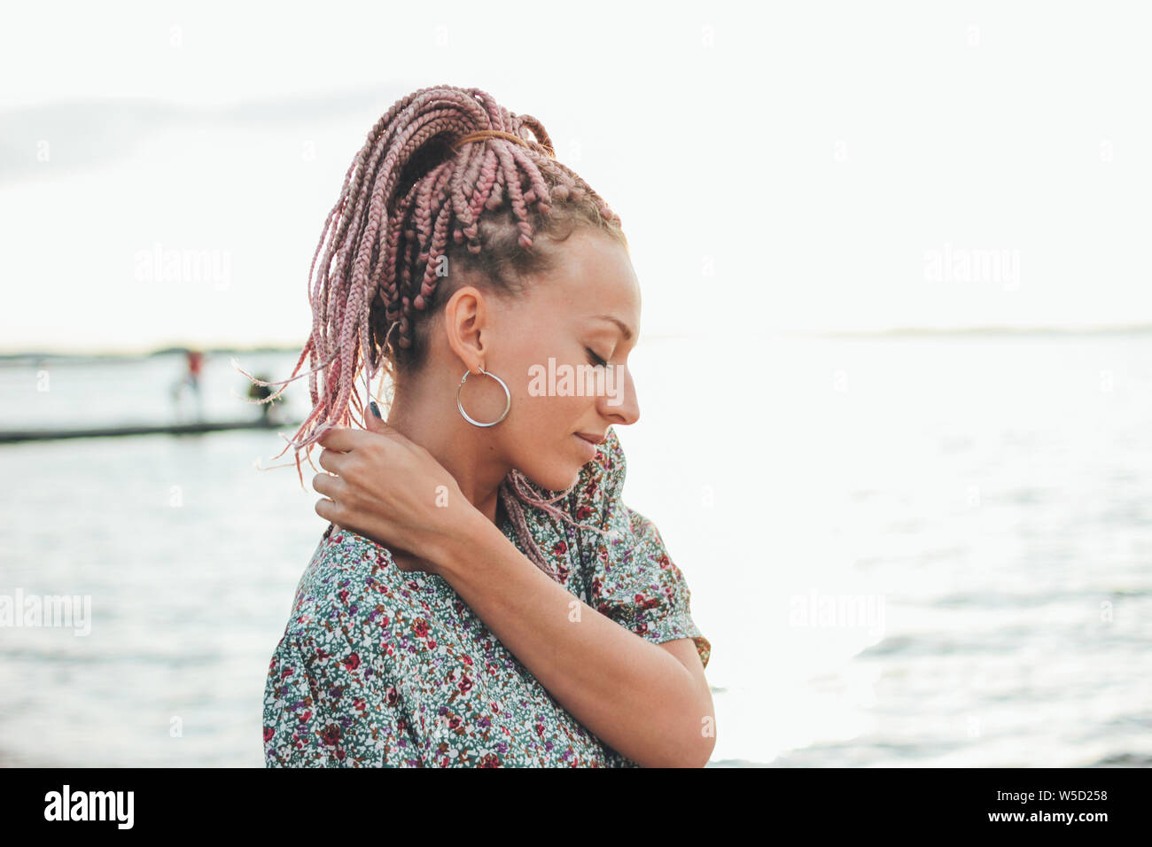 Carefree romantic young woman with african braids enjoy her life on the beach, summer vacation time Stock Photo
