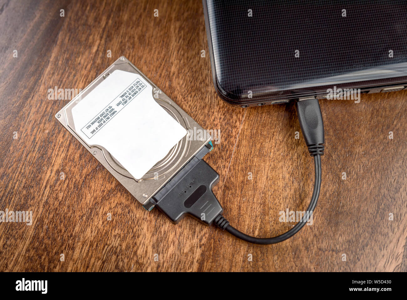 Hdd 2 5 Internal Hard Drive Disk Connected To Laptop Via Sata Usb Cable On Wooden Table Closeup View Stock Photo Alamy