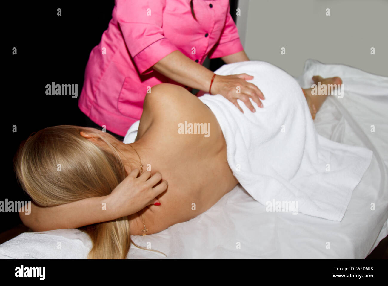 professional therapeutic massage. girl the athlete in a massage room. body and health care image