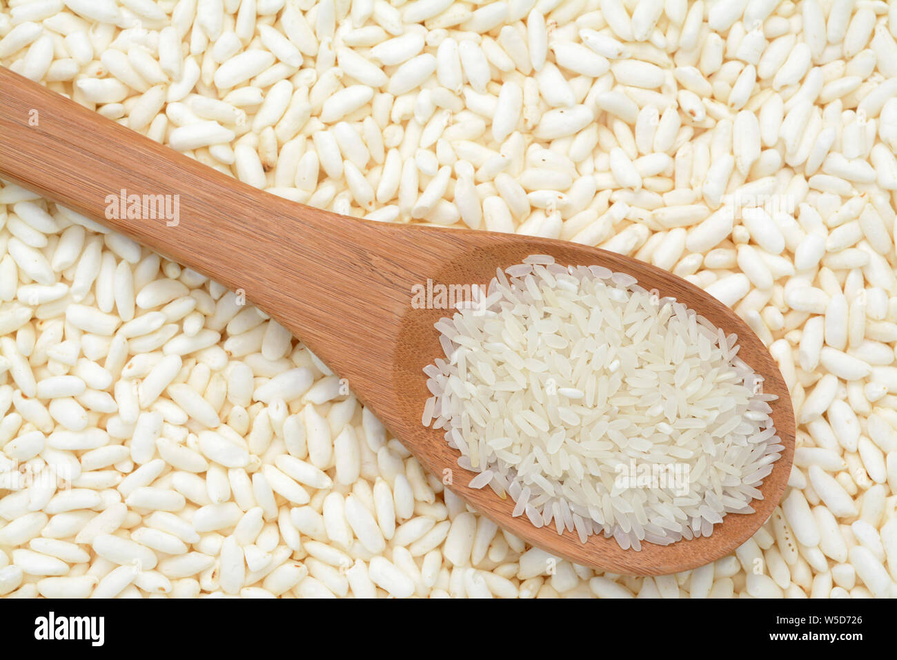 a spoon of rice on puffed rice cereal background Stock Photo - Alamy