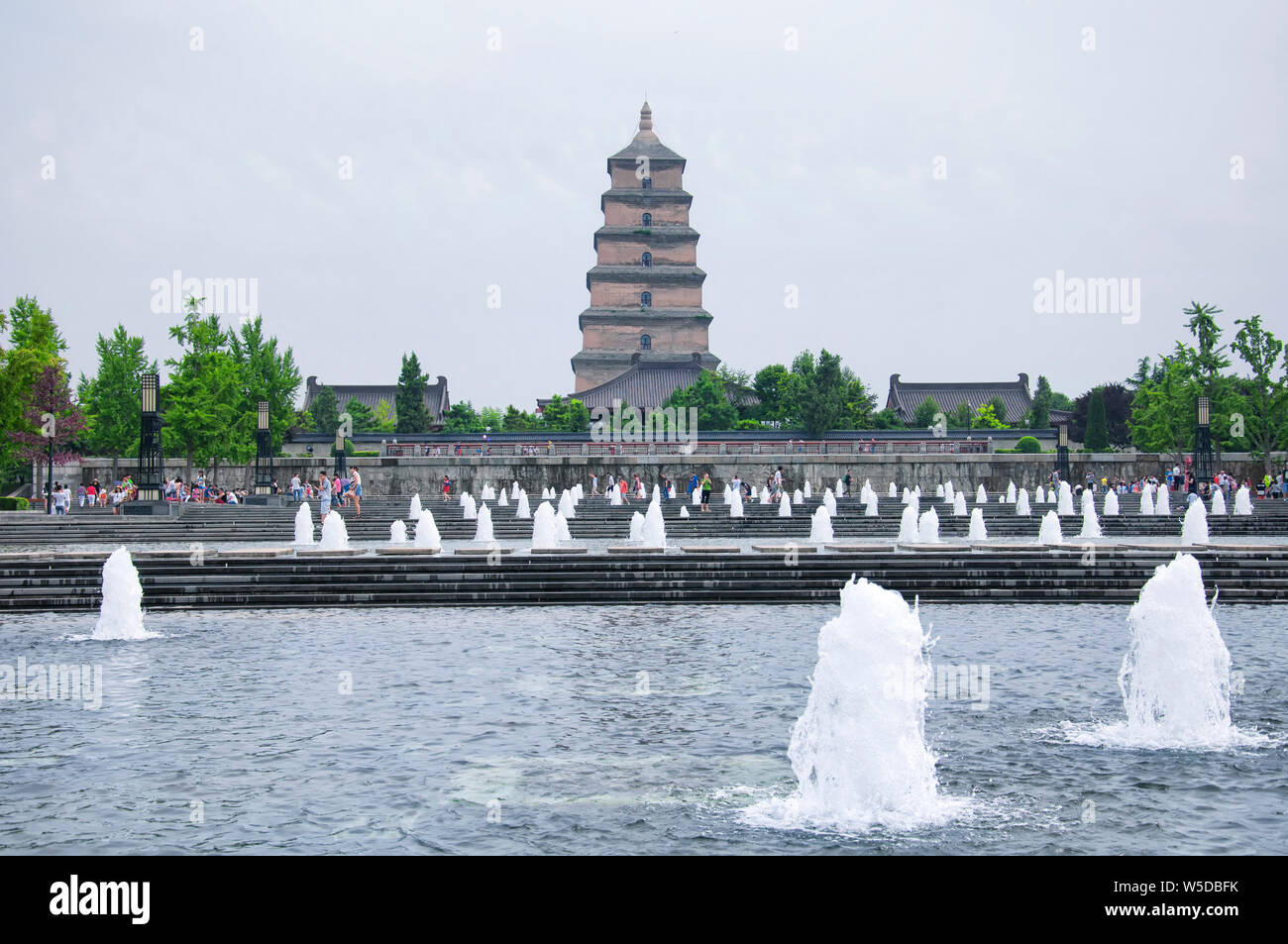 August 19, 2015.  Xian China.  The North Square Tang Cultural area water fountain and great wild goose pagoda in Shaanxi province on an overcast day. Stock Photo
