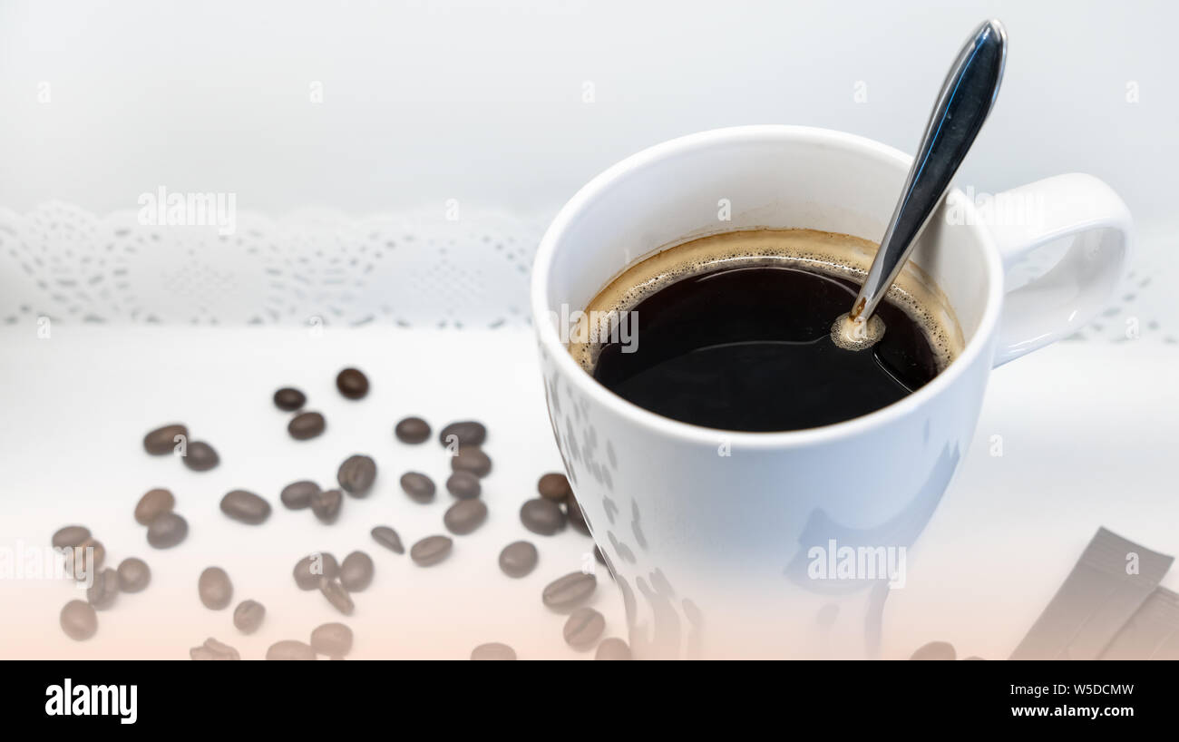 Cup of coffee with spoon, coffee beans on white background Stock Photo ...