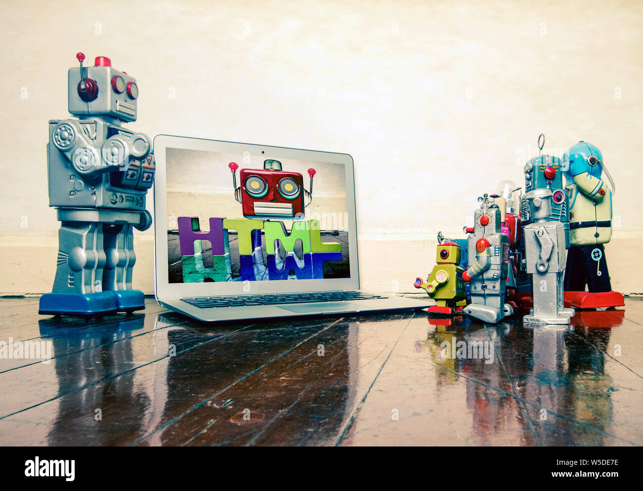 silver robot teaching about code HTML to kid robot toys Stock Photo - Alamy