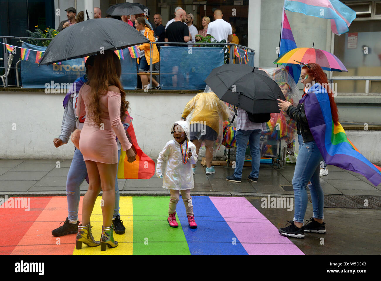 People posing on rainbow at Pride Event, Nottingham, Stock Photo