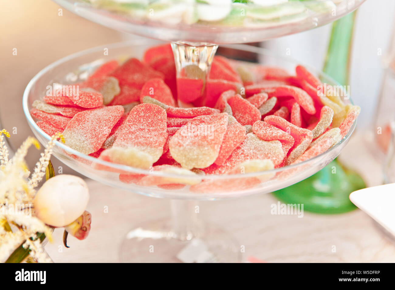 Fruit sweets on glass stand, candy and oriental sweets, treat at a summer picnic, selective focus Stock Photo