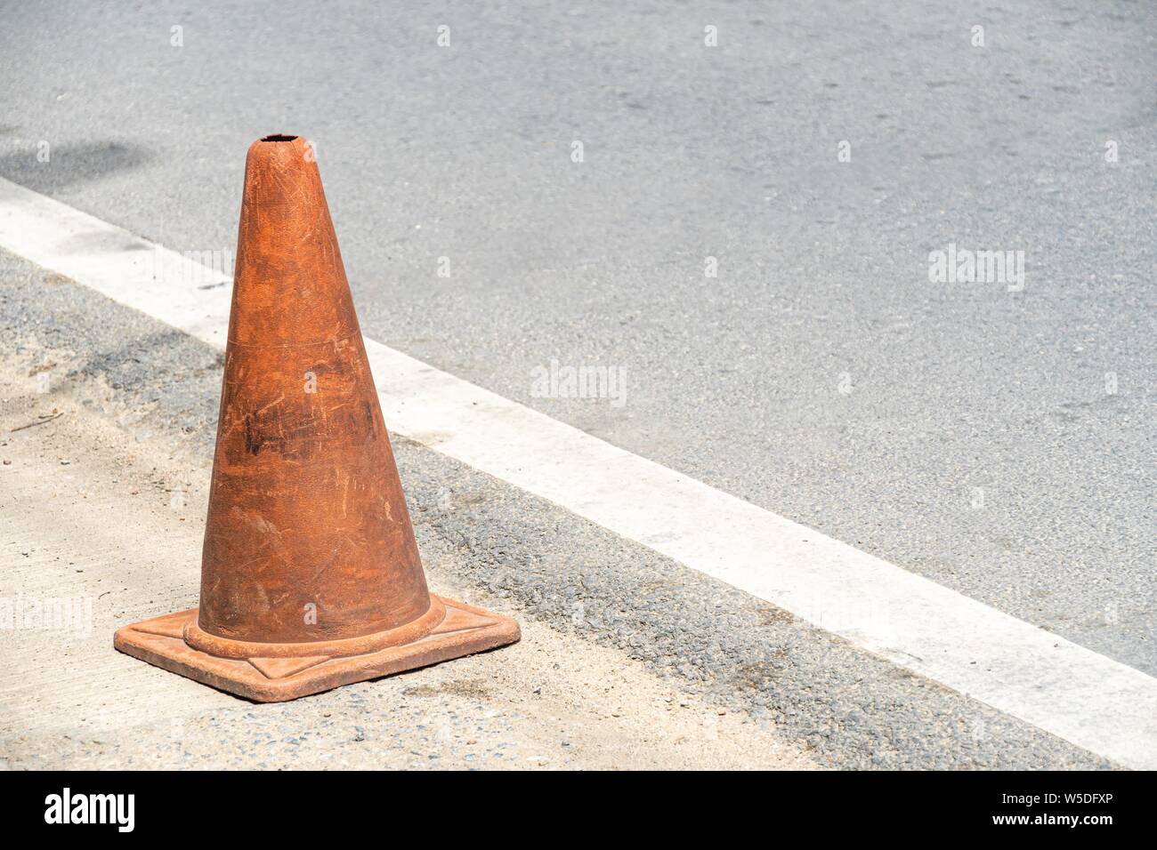 Old Traffic cones, also called pylons, witches' hats, road cones, highway cones, safety cones, channelizing devices, or construction cones Stock Photo