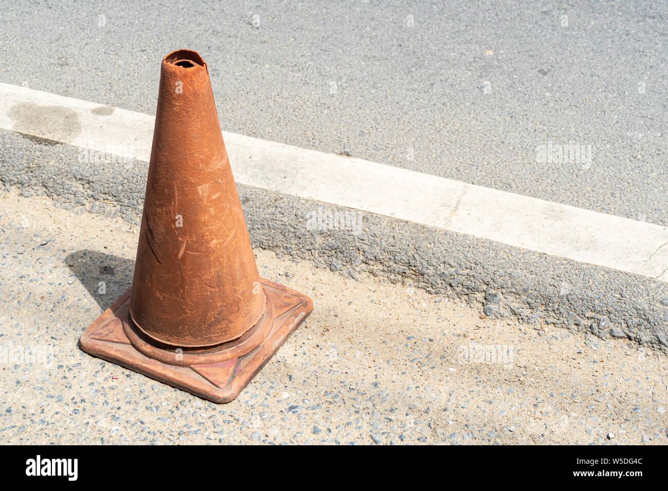 Old Traffic cones, also called pylons, witches' hats, road cones, highway cones, safety cones, channelizing devices, or construction cones Stock Photo