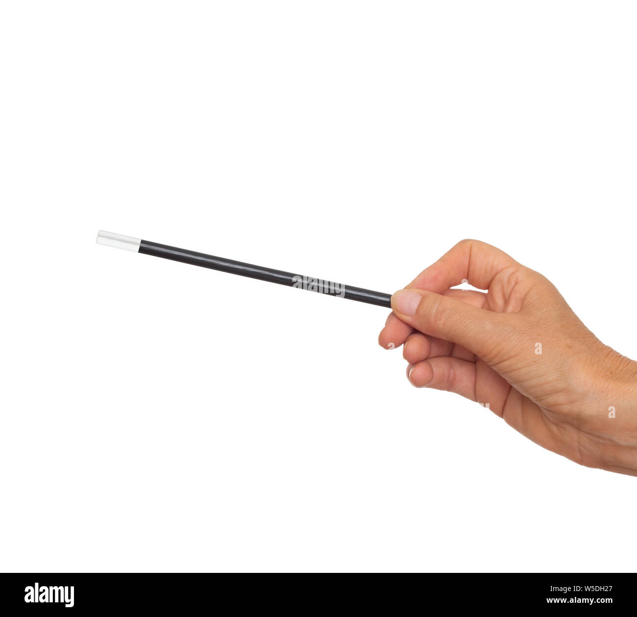 Female hand with traditional magician's black and white magic wand isolated on white background. Stock Photo
