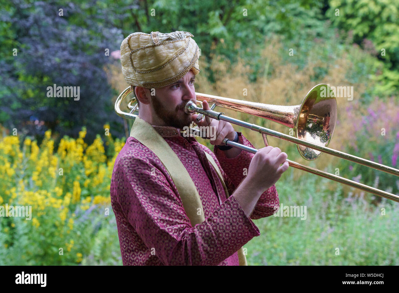 Trombone Player from The Bombay Baja Brass Band, Valley Gardens, Harrogate, North Yorkshire, England, UK. Stock Photo