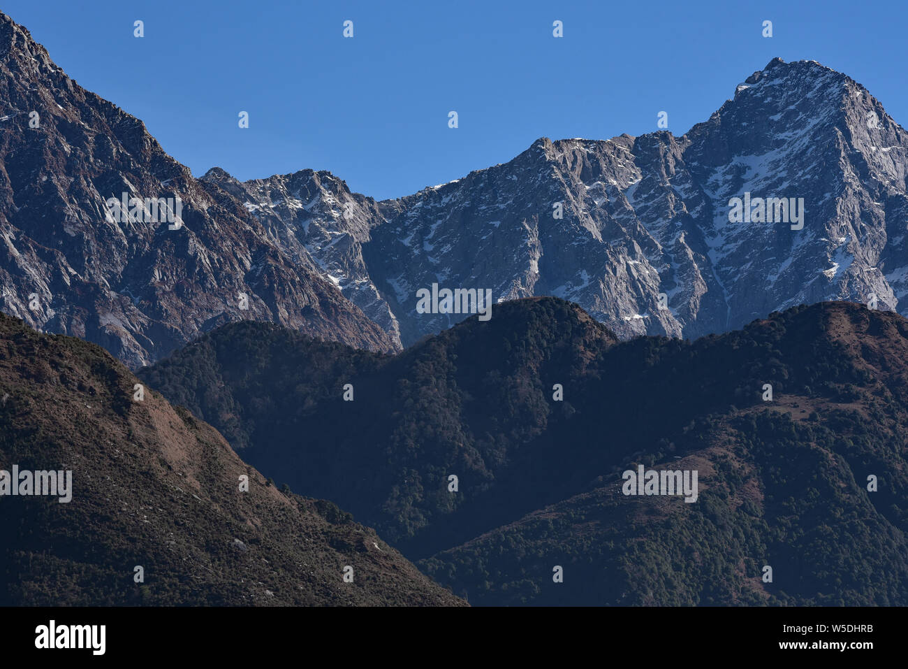 The dramatic rocky peaks of the Dhauladhar Range, part of the Lower Himalayan Range, McLeodganj, Kangra district, Himachal Pradesh, North India, Asia. Stock Photo