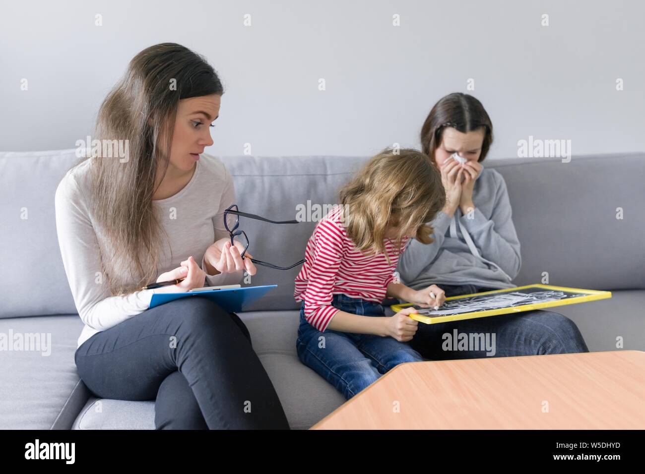 Child professional psychologist working with family, two sisters in