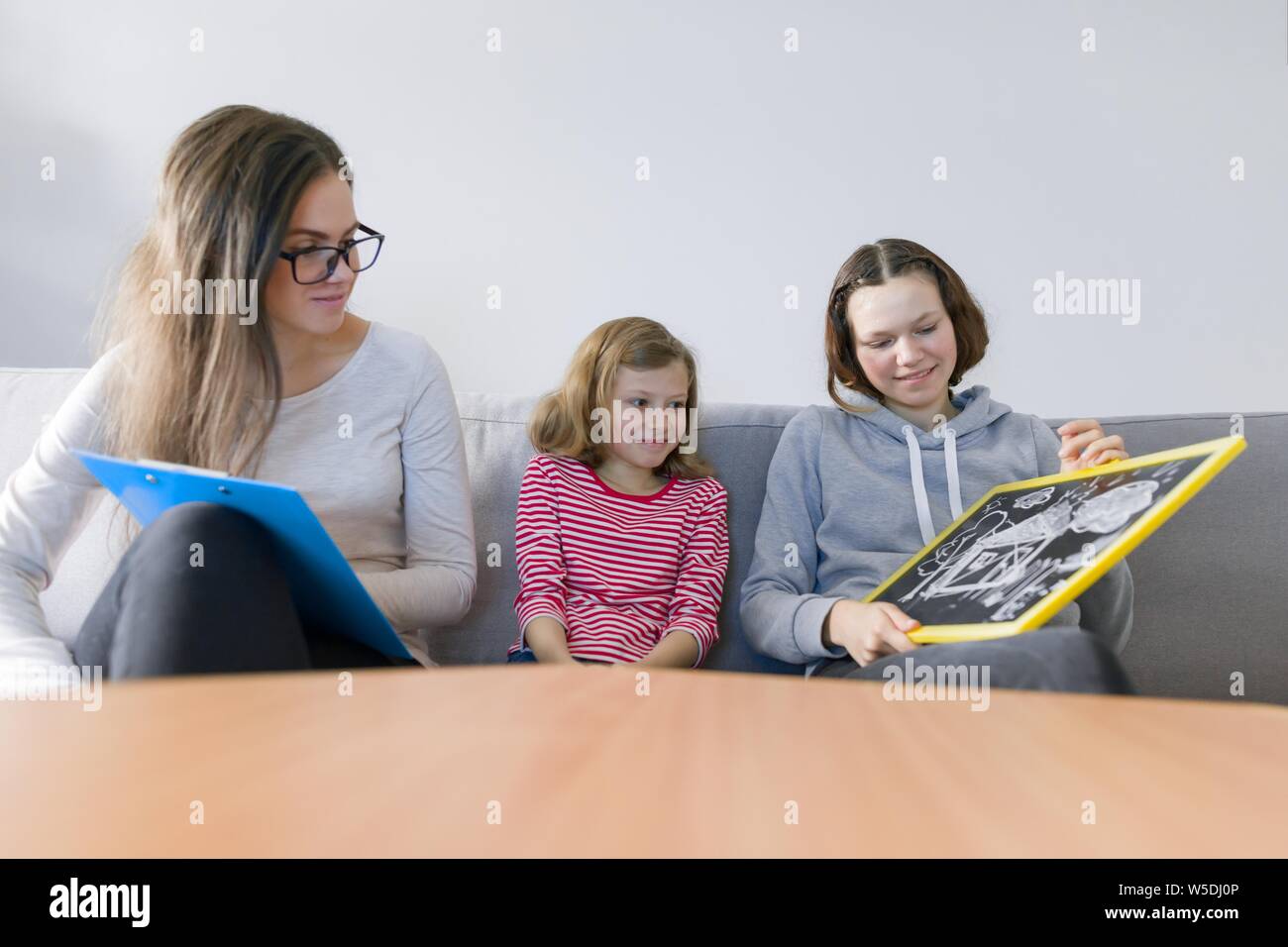 Child professional psychologist working with family, two sisters in