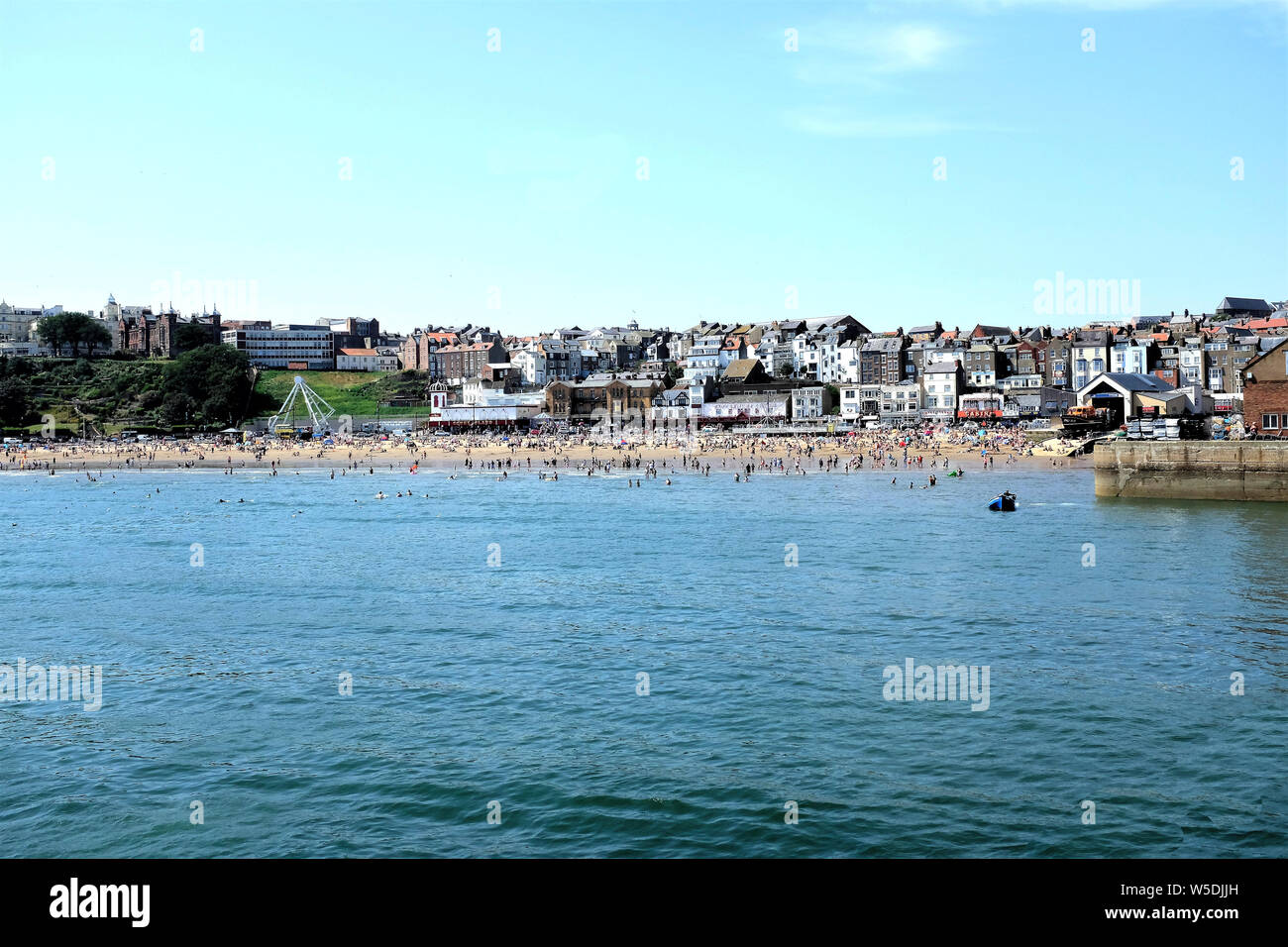 Scarborough, Yorkshire, UK. July 25, 2019. A busy South beach as holidaymakers enjoy a Summer day at the seaside taken from the pier at Scarborough in Stock Photo