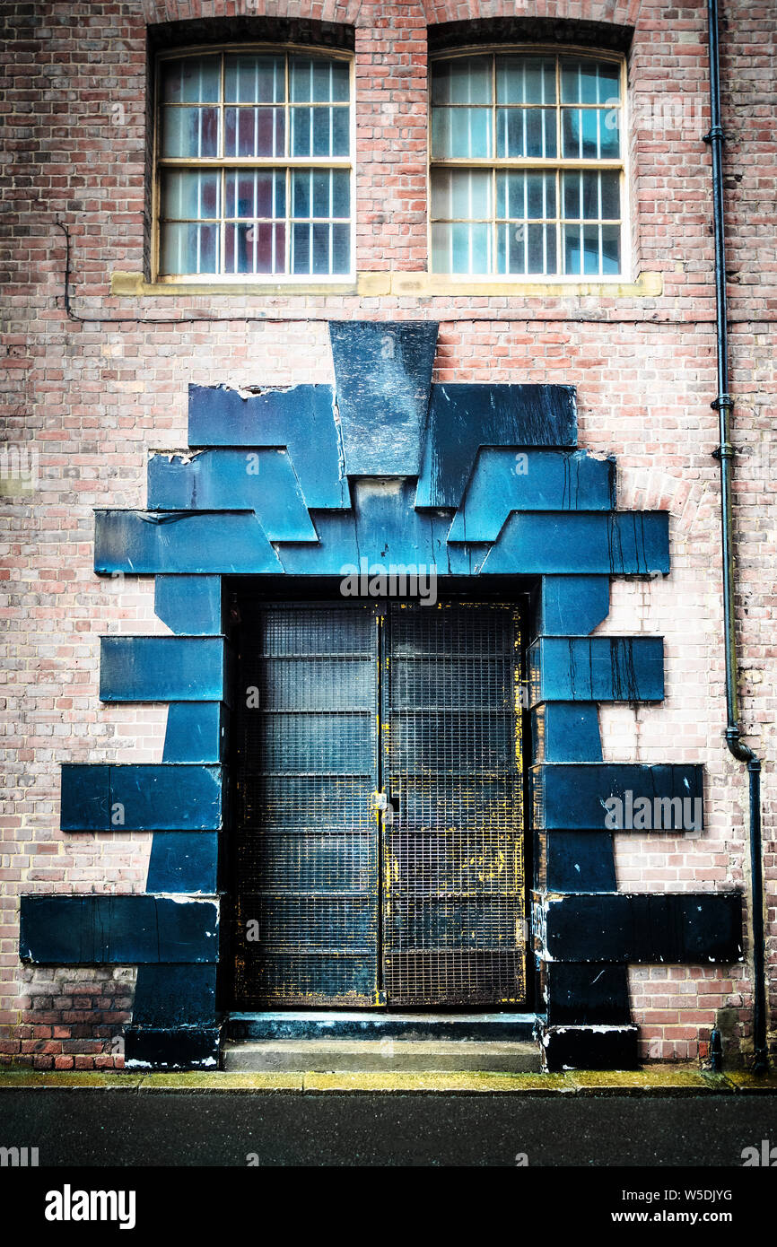 Double black steel doors with ornate decorative surround, in Newcastle