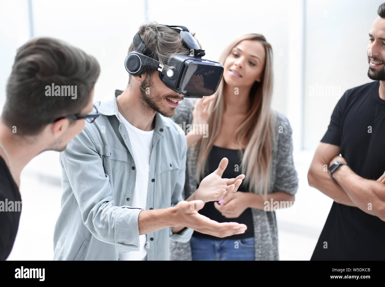 Positive colleagues testing virtual reality glasses Stock Photo