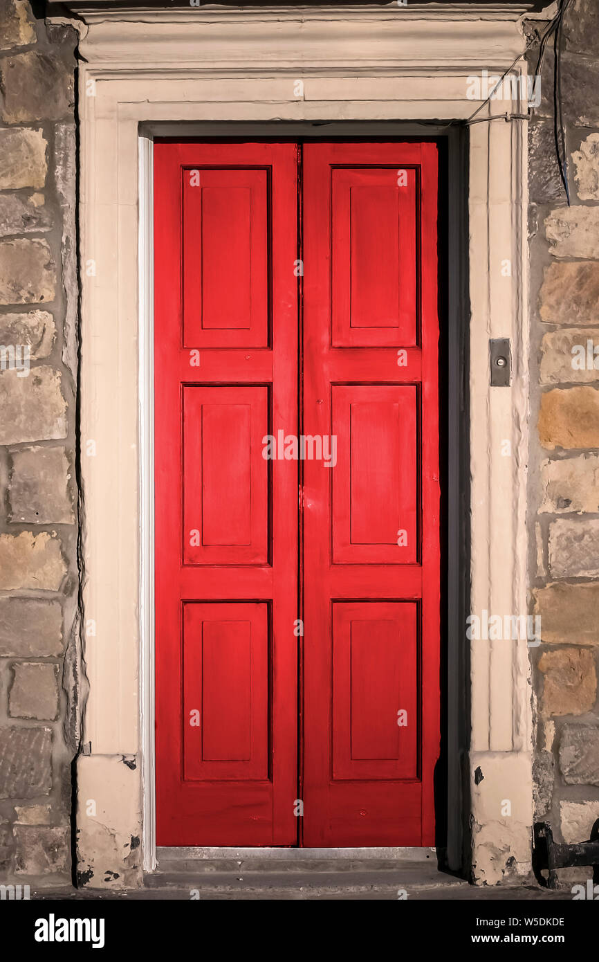 Red painted panelled double doors to a building in Newcastle upon Tyne