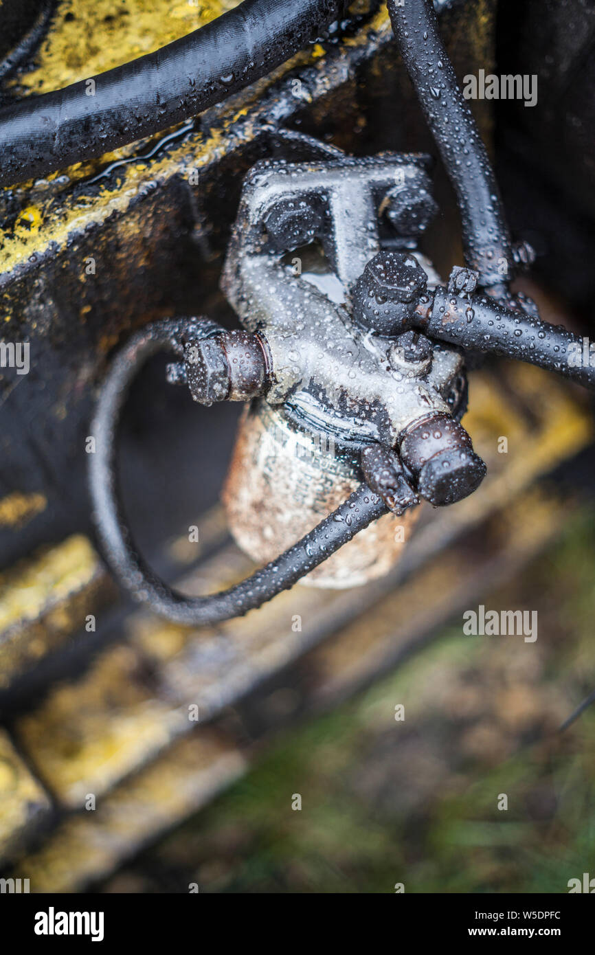 Close up of oily, dirty old fuel filter on machinery in a scrap yard near Consett, County Durham, England, UK Stock Photo