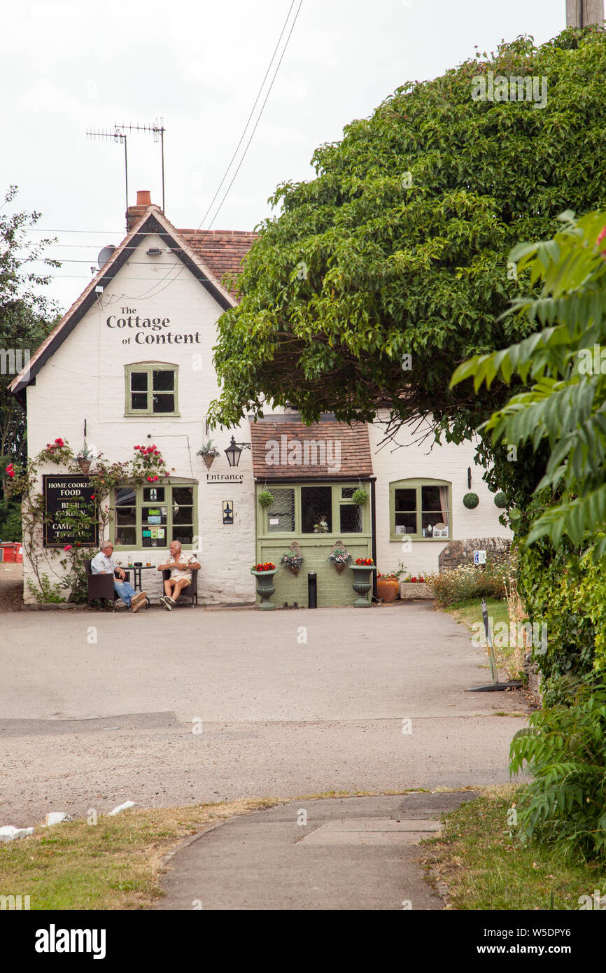 People Sitting Drinking Outside The Cottage Of Content Country Pub