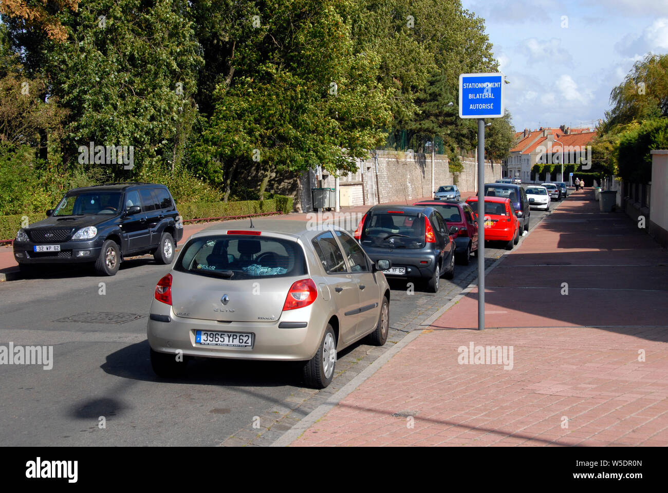 Cars parked legally on both sides of the street, Calais, France Stock Photo