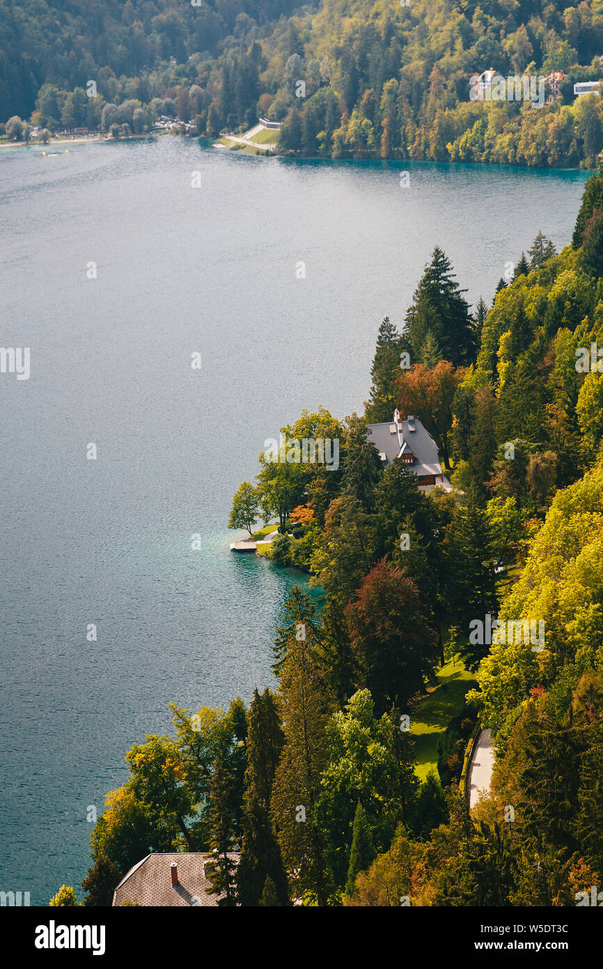 Close up aerial view of the part of the lake Bled in Slovenia. A small house on the bank surrounded by forest Stock Photo