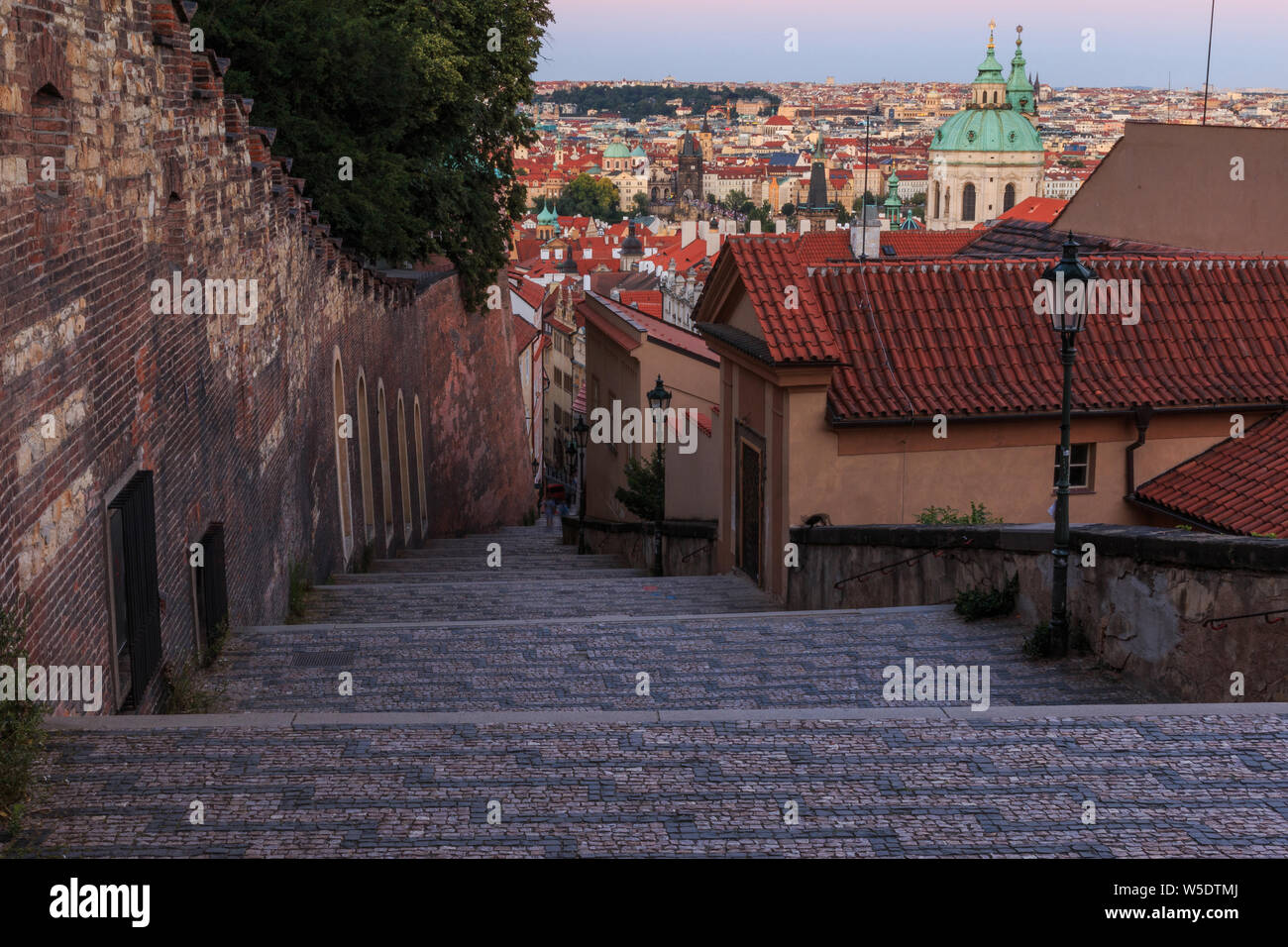 Pananorma view over the old town of Prague in the evening. Steps lead from the Prague Castle down to the district of Lesser Town. Historical brickwork Stock Photo