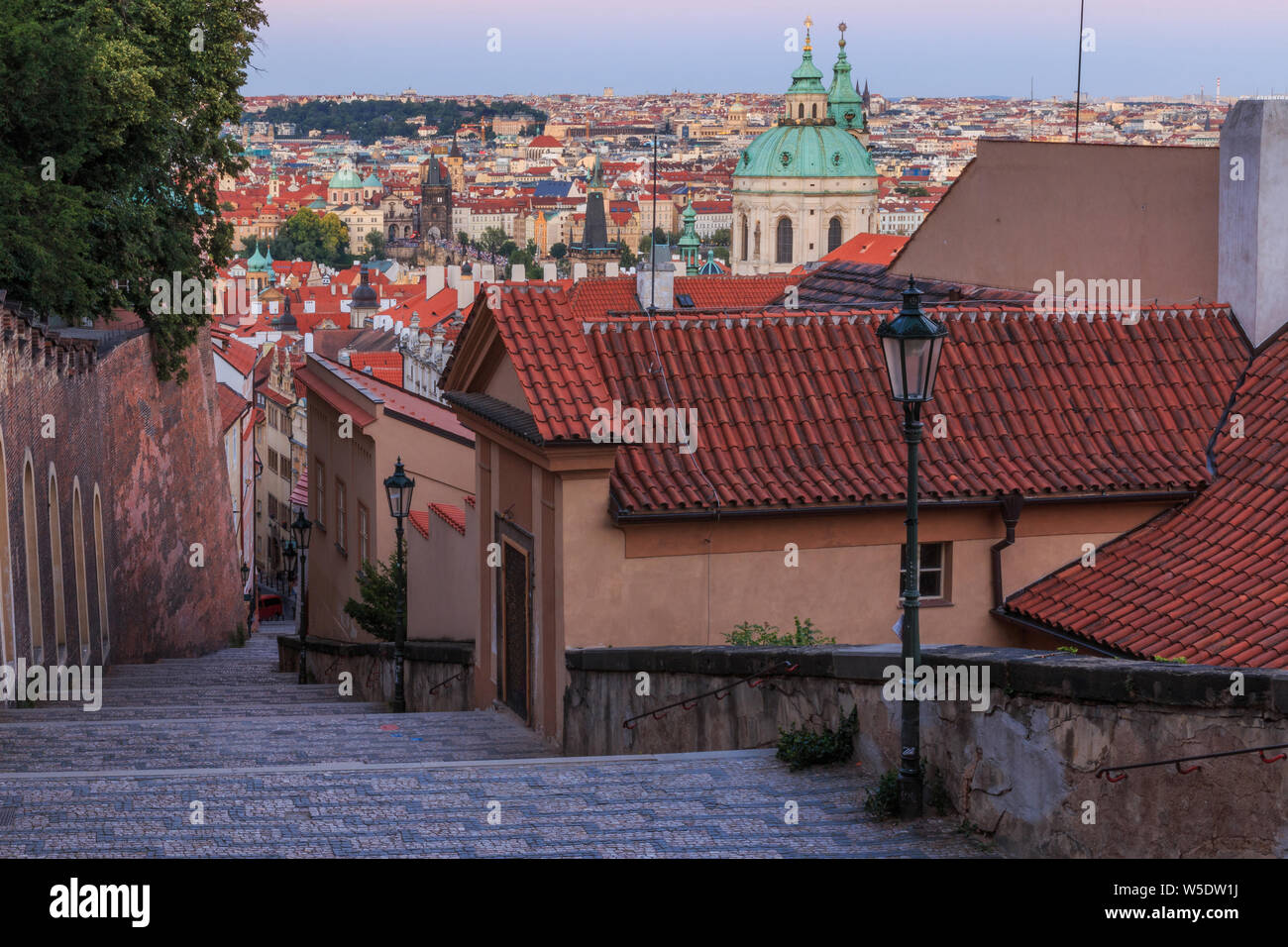 Steps lead from the Prague Castle down to the district Lesser Town with Pananorma view over the old town of Prague in the evening,Charles Bridge Stock Photo