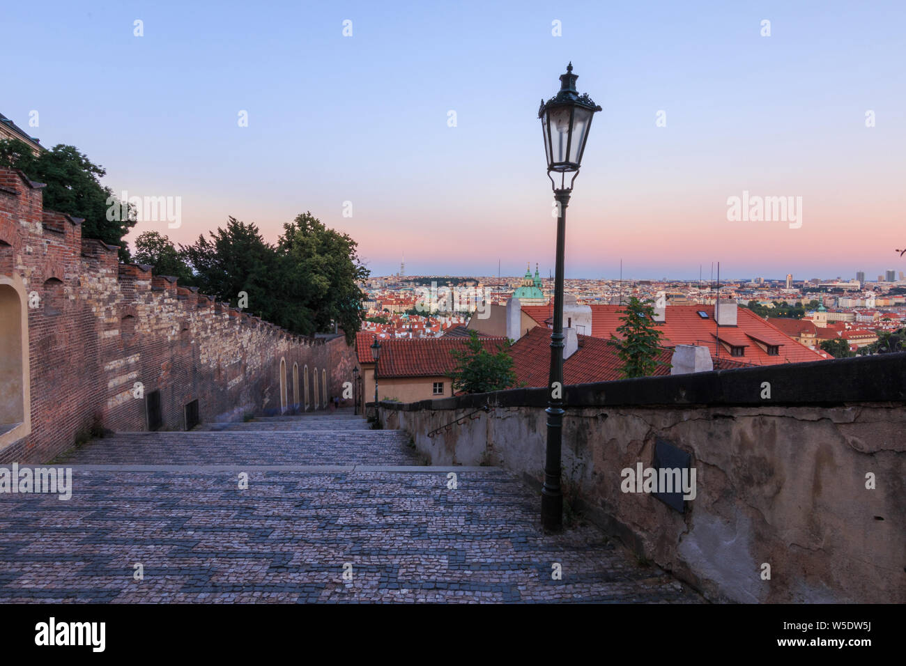 City view over the rooftops of the old town of Prague in the evening. Steps from the Prague Castle down to the district Lesser Town. Historic masonry Stock Photo