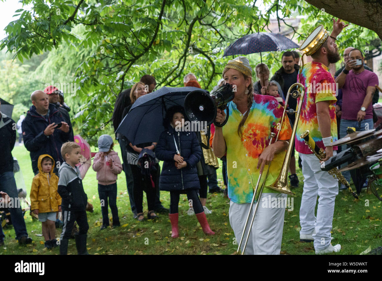 Female Trombone player from Mr Wilson's Second Liners singing through a Loud Hailer at The Valley Gardens Carnival, Harrogate, North Yorkshire, UK. Stock Photo
