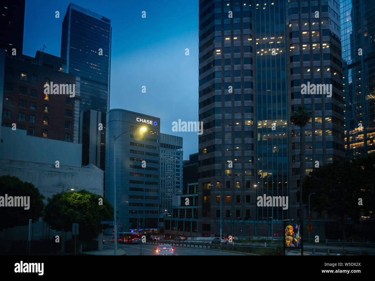 Los Angeles California USA. June 1st, 2019. Skyscrapers illuminated, car lights on the street, blue sky background, spring evening Stock Photo