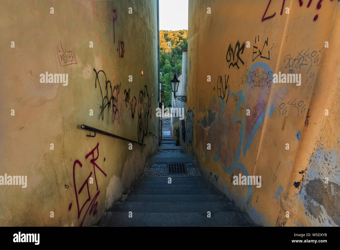 Narrow alley with steps and railing from Hradcany Square down to Prague ...